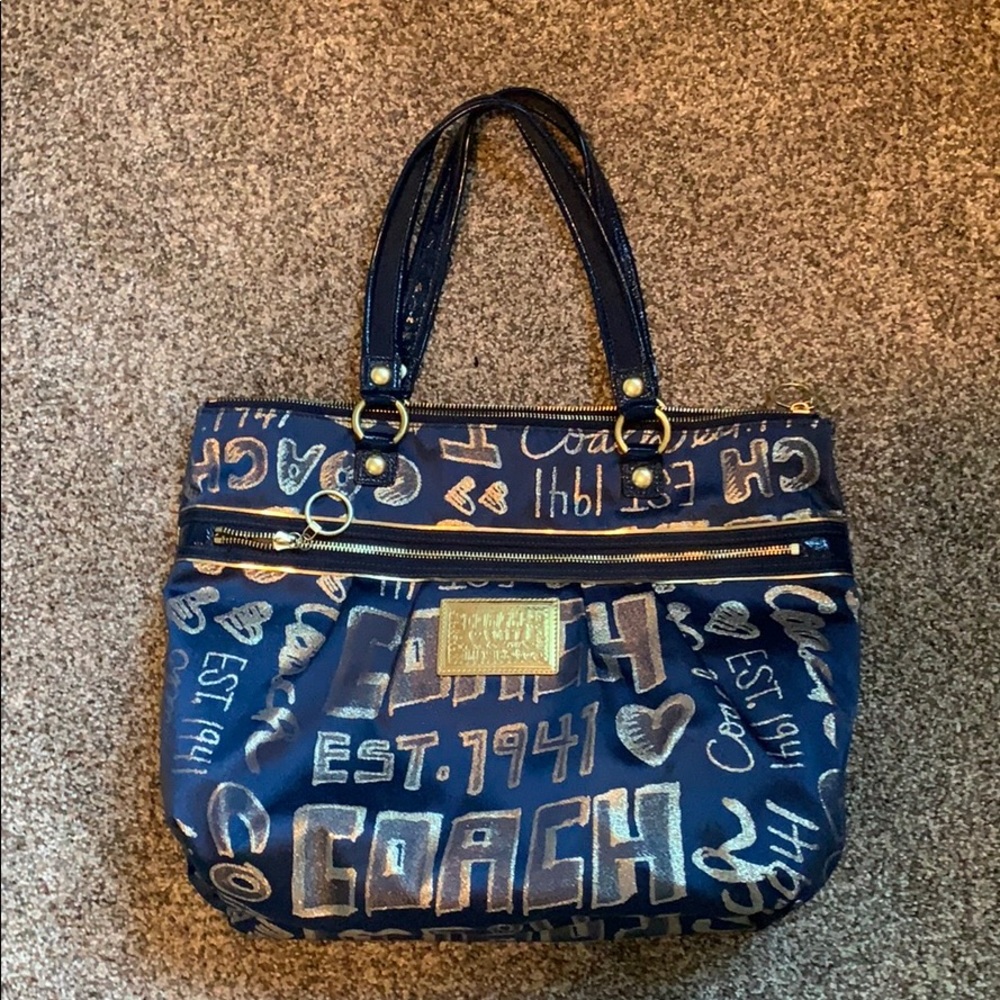 Navy blue and gold Poppy Coach purse.